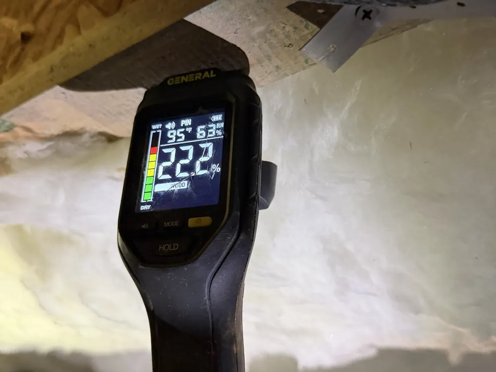 A moisture meter reading 22.2% on crawl space framing during a Crawl Space Doctors inspection
