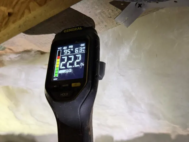 A moisture meter reading 22.2% on crawl space framing during a Crawl Space Doctors inspection