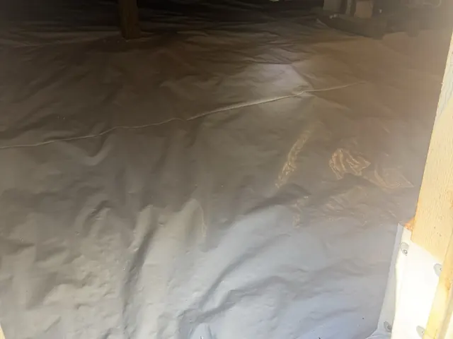 A finished encapsulation: white liner across the floor and up the wall