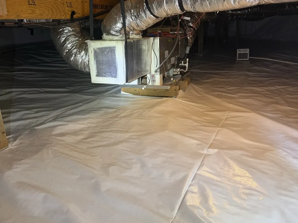 The air handler on a finished white liner after Crawl Space Doctors sealed the space