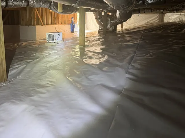 Ductwork over a finished white crawl space liner on a Crawl Space Doctors job